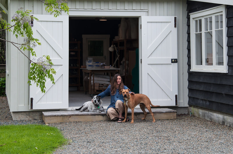 Vicki Fanning of Frolic Ceramics outside her Matakana studio with her dogs